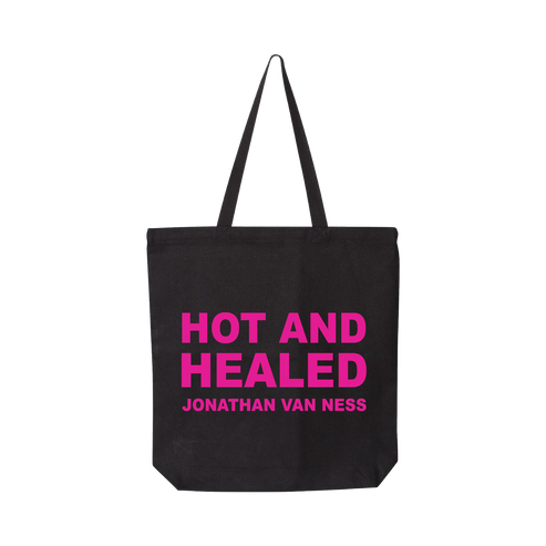 Jonathan Van Ness Hot and Healed black canvas tote bag with long black handles, featuring the text 'HOT AND HEALED' and 'JONATHAN VAN NESS' printed in bright pink on the front.