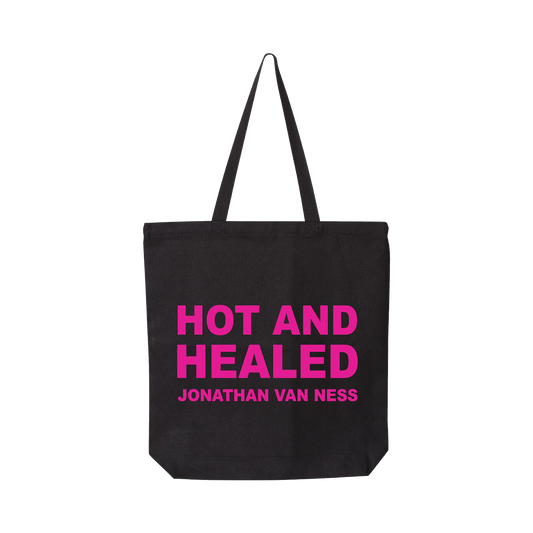 Jonathan Van Ness Hot and Healed black canvas tote bag with long black handles, featuring the text 'HOT AND HEALED' and 'JONATHAN VAN NESS' printed in bright pink on the front.